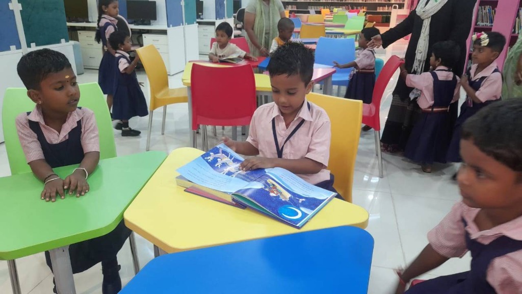 Children reading colorful picture storybooks in the school library